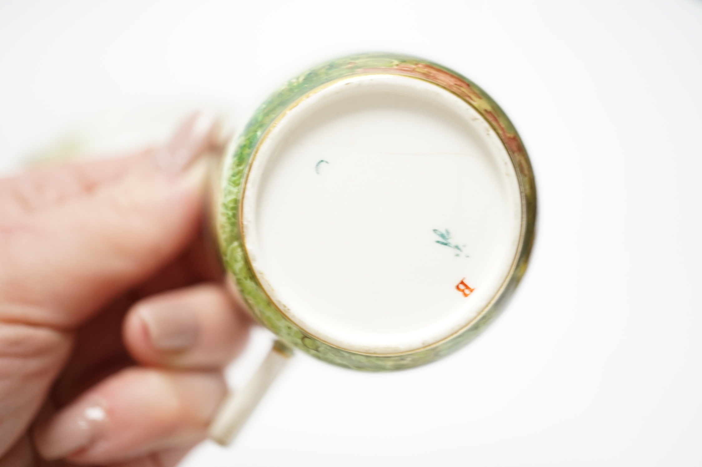 A Minton porcelain cup and saucer, painted with deer by Edouard Rischgitz